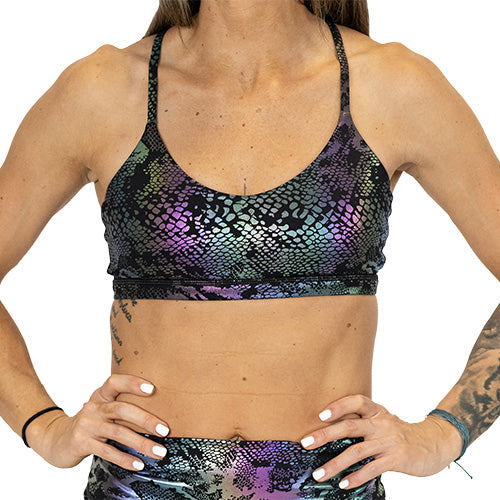 front view of black, purple and green holographic sports bra