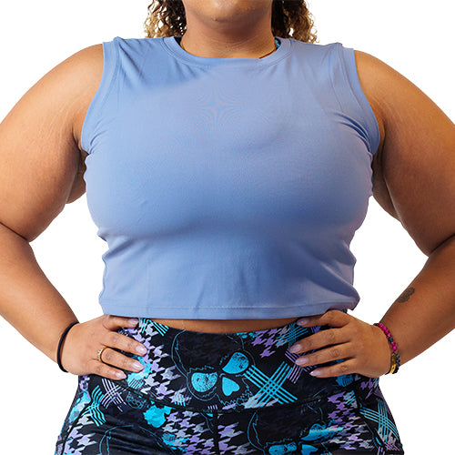 Close up photo of a model wearing a blue fitted crop top