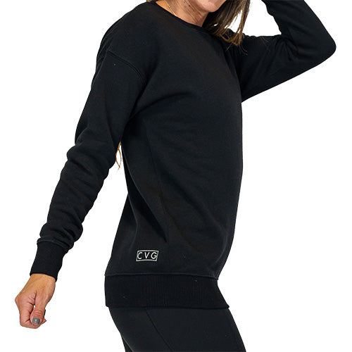 Photo of the side of a basic black crewneck with the CVG logo on the back right corner