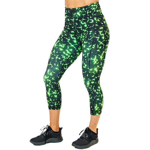 front view of capri length lime green and black dot print leggings