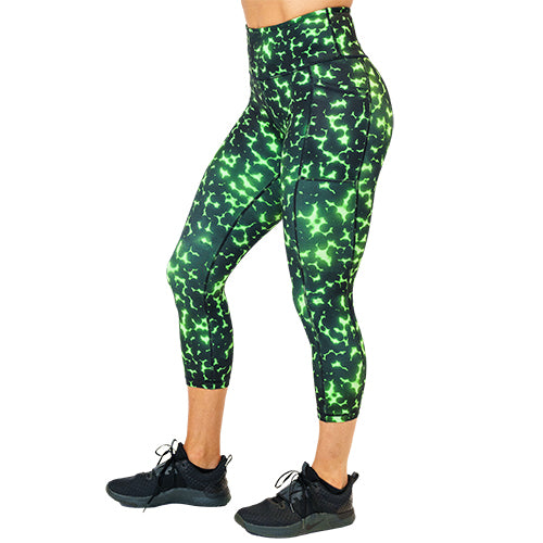 side view of capri length lime green and black dot print leggings