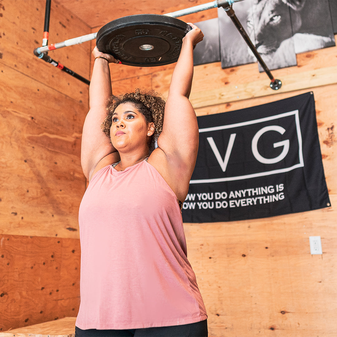 model wearing a light pink high neck flowy tank top