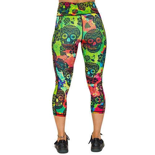 back view of capri colorful tie dye leggings with black skull pattern