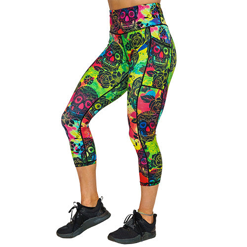 side view of capri length colorful tie dye leggings with black skull pattern