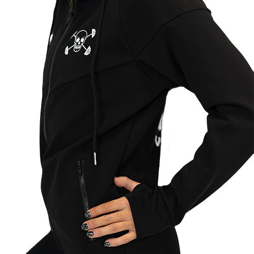 Photo of the side of a model showing the zipper pockets on the black zip up sweatshirt and the CVG skull logo on the top left of the sweatshirt