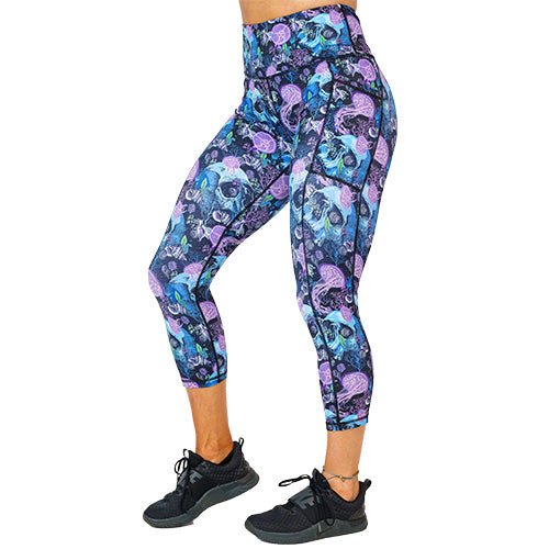 side view of capri length purple jelly fish and blue skull print leggings