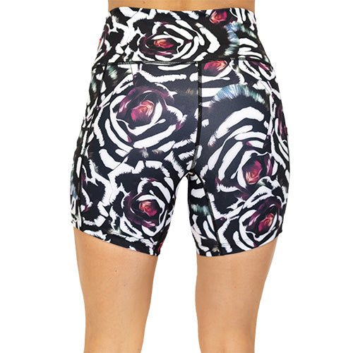 back view of blue, pink, white petal design on black 5" shorts