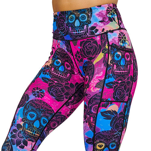 close up of purple, pink and blue tie dye leggings with black skull and rose pattern