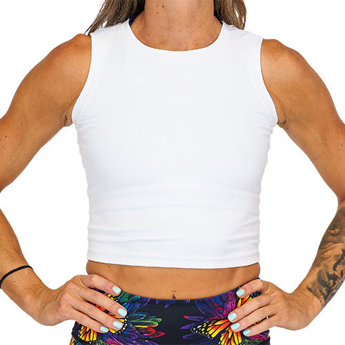 Close up photo of a model wearing a white fitted crop top