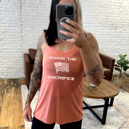 coral tank with the saying "honor the sacrifice" and an American flag in white