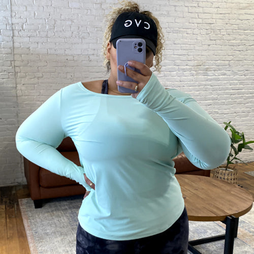 model taking a selfie of the mint green long sleeve shirt