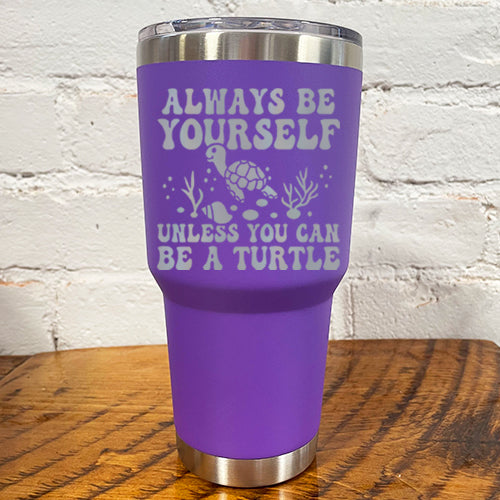 30oz purple tumbler with silver saying "always be yourself unless you can be a turtle" with turtle cartoon, seaweed, shells and bubbles