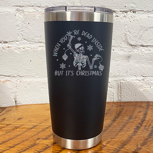20oz black tumbler with silver saying "when you're dead inside but it's christmas" with a santa hat skeleton holding ornaments