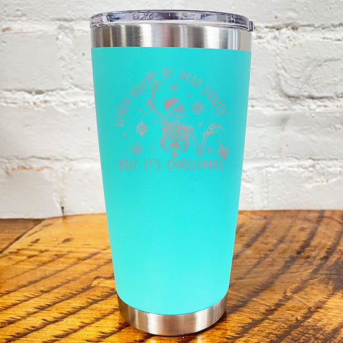 20oz teal blue tumbler with silver saying "when you're dead inside but it's christmas" with a santa hat skeleton holding ornaments