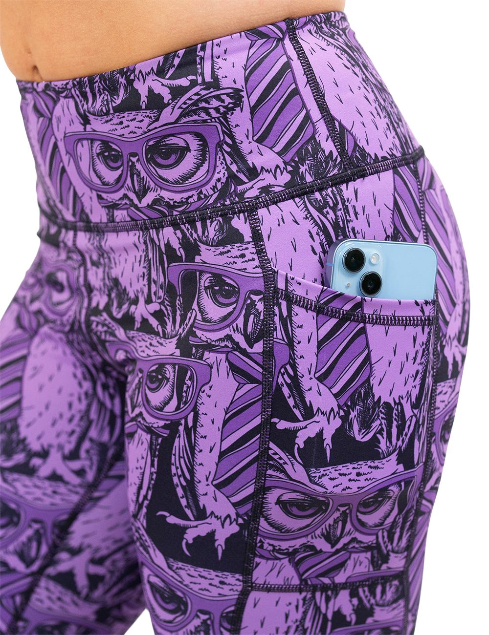 close up of the purple owl wearing glasses and a tie print leggings with a phone in the pocket