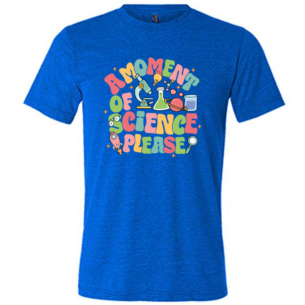 Blue colored shirt with laboratory items graphic on it that says "A Moment of Science Please"