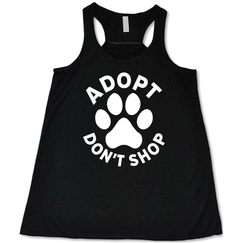 Black colored flowy tank with paw print graphic on it that says "Adopt Don't Shop"