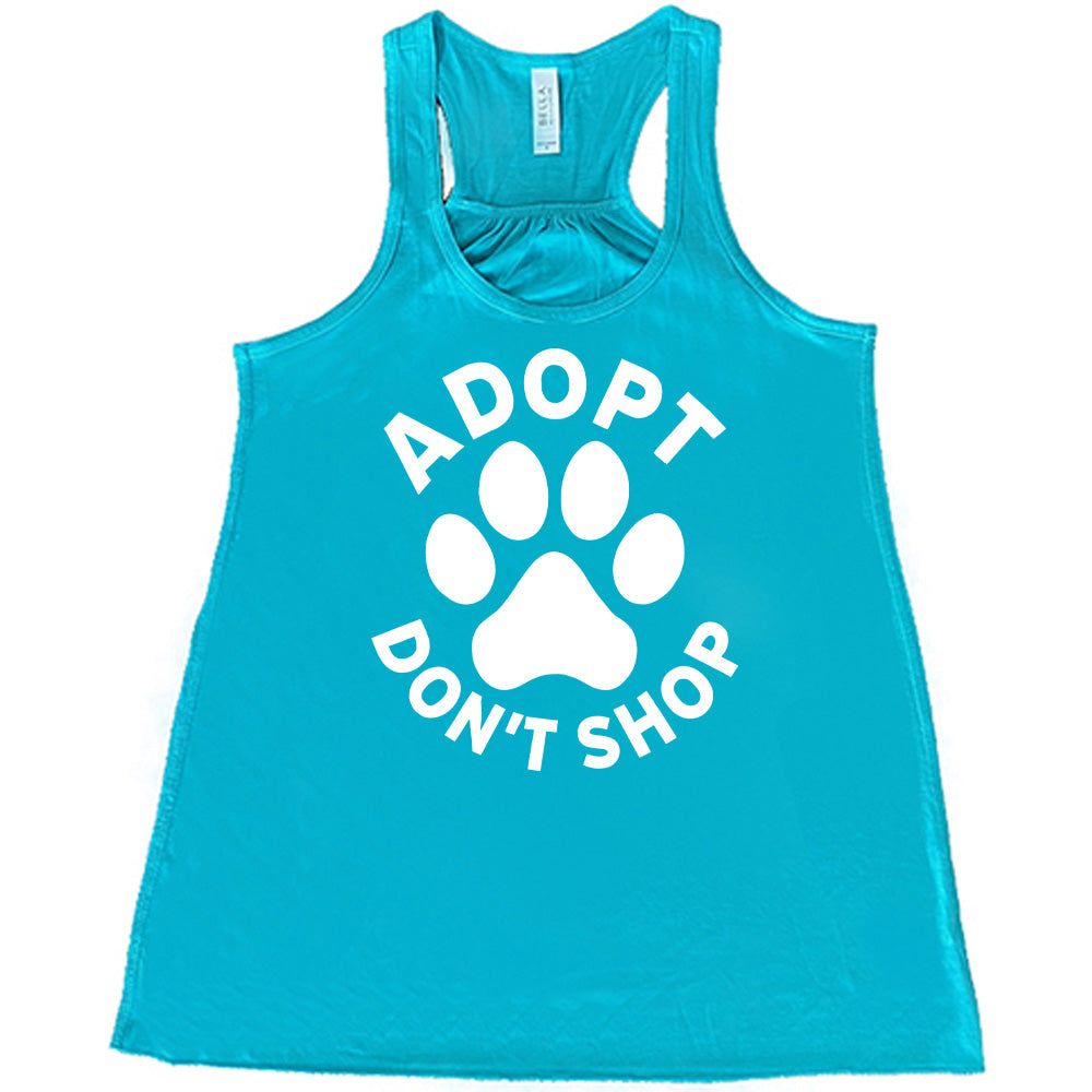 Teal colored flowy tank with paw print graphic on it that says "Adopt Don't Shop"
