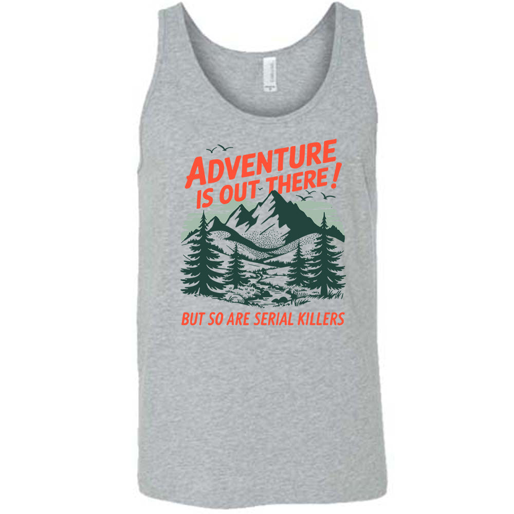 grey unisex tank with the words "adventure is out there! but so are serial killers" on it, with the graphic of mountains and woods and birds flying 