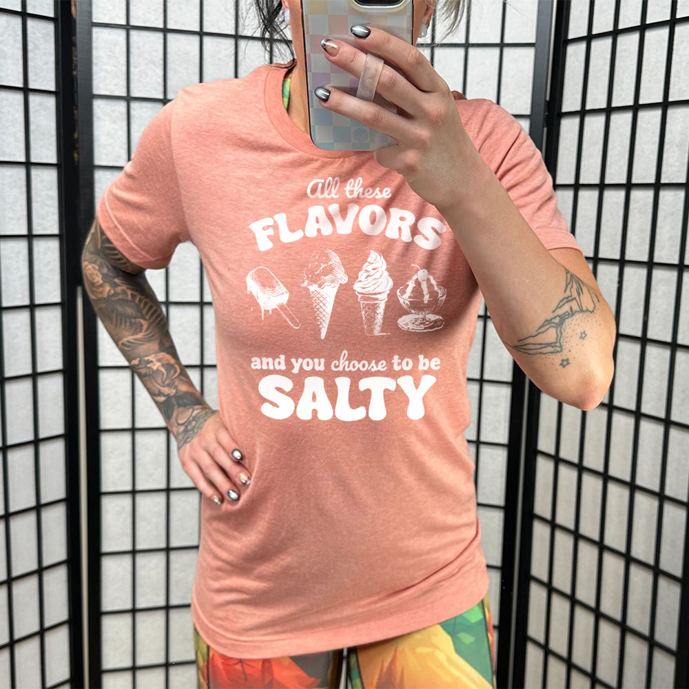 sunset unisex tee with the words "all these flavors and you choose to be salty" on it, with graphics including a popsicle, two ice cream cones, and a sundae