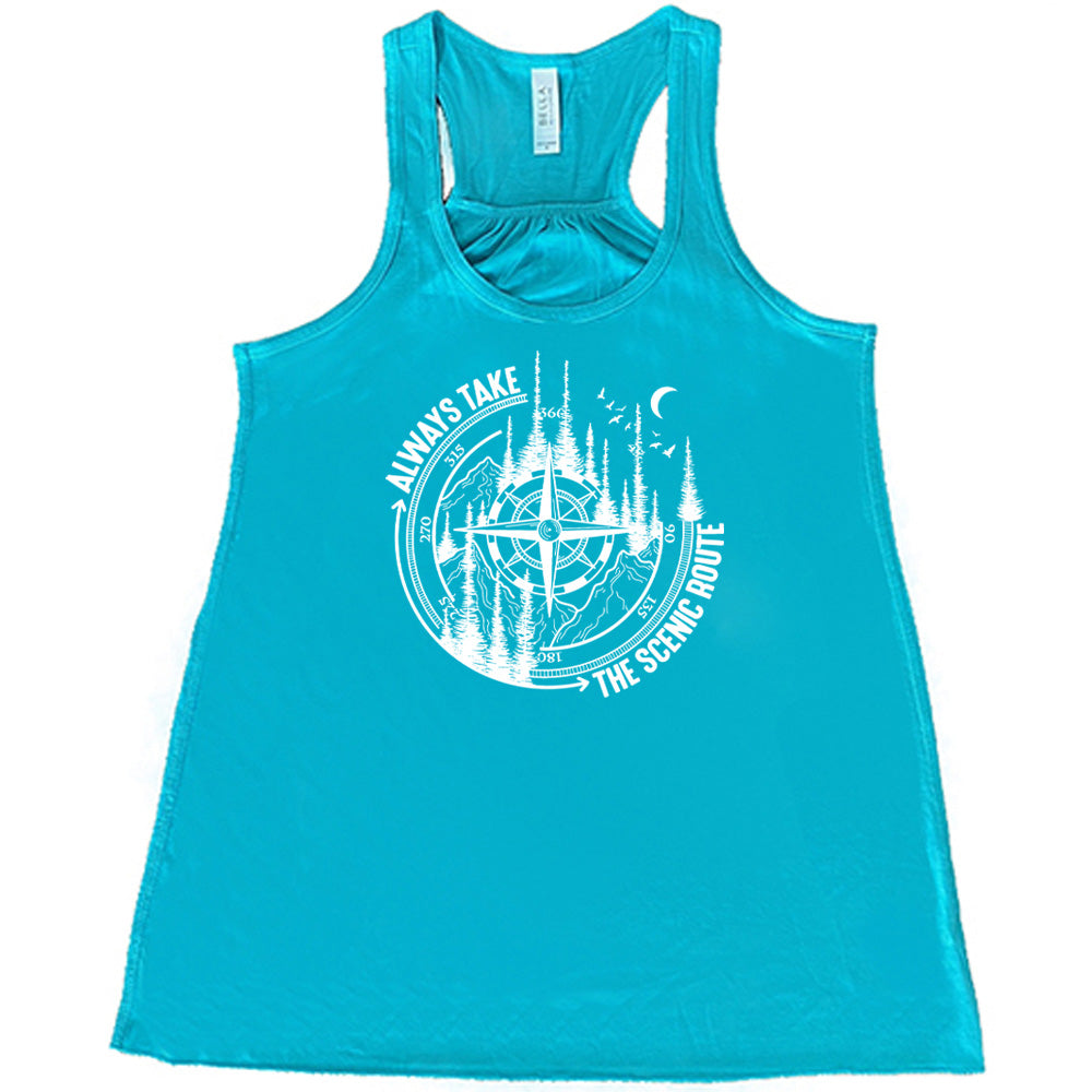 Teal colored flowy tank with a compass and forest graphic on it that says "Always Take The Scenic Route" 