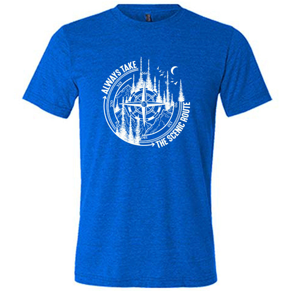 Blue colored shirt with a compass and forest graphic on it that says "Always Take The Scenic Route"