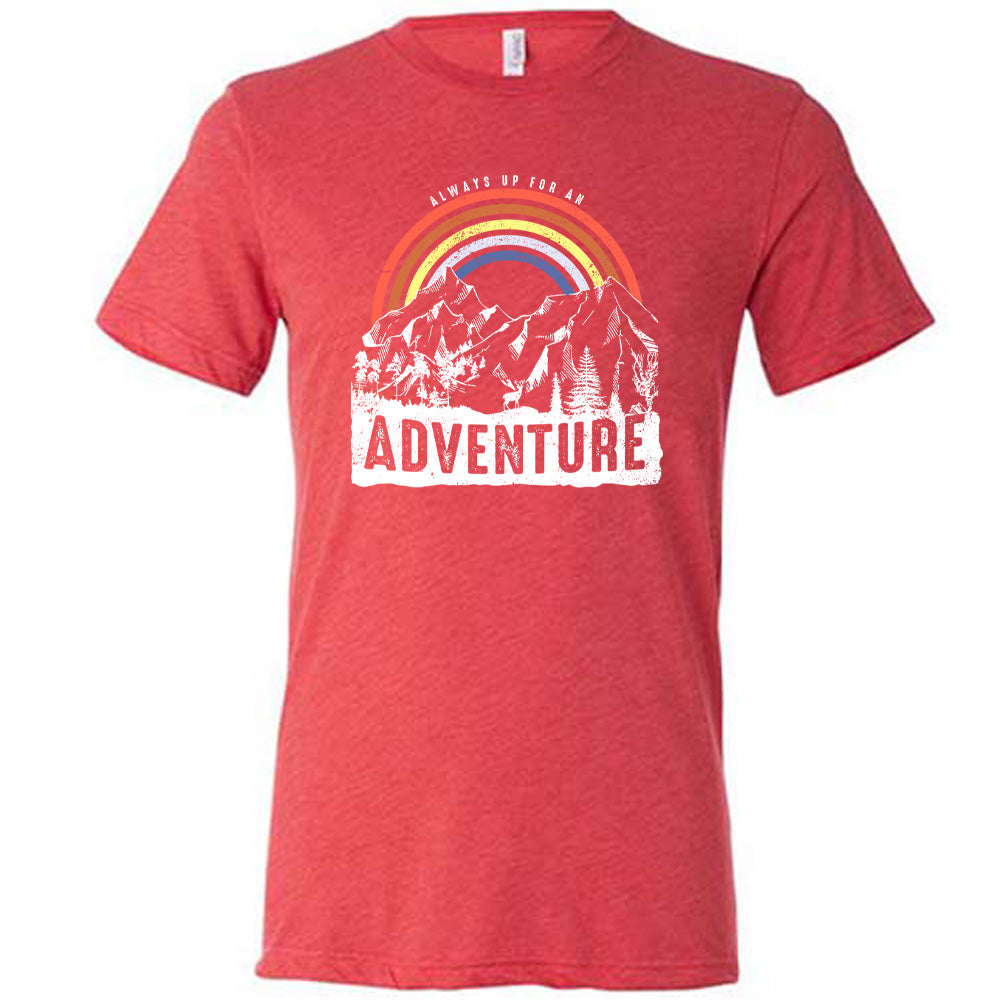 Red colored shirt with a rainbow over mountains graphic on it that says "Always Up For An Adventure"