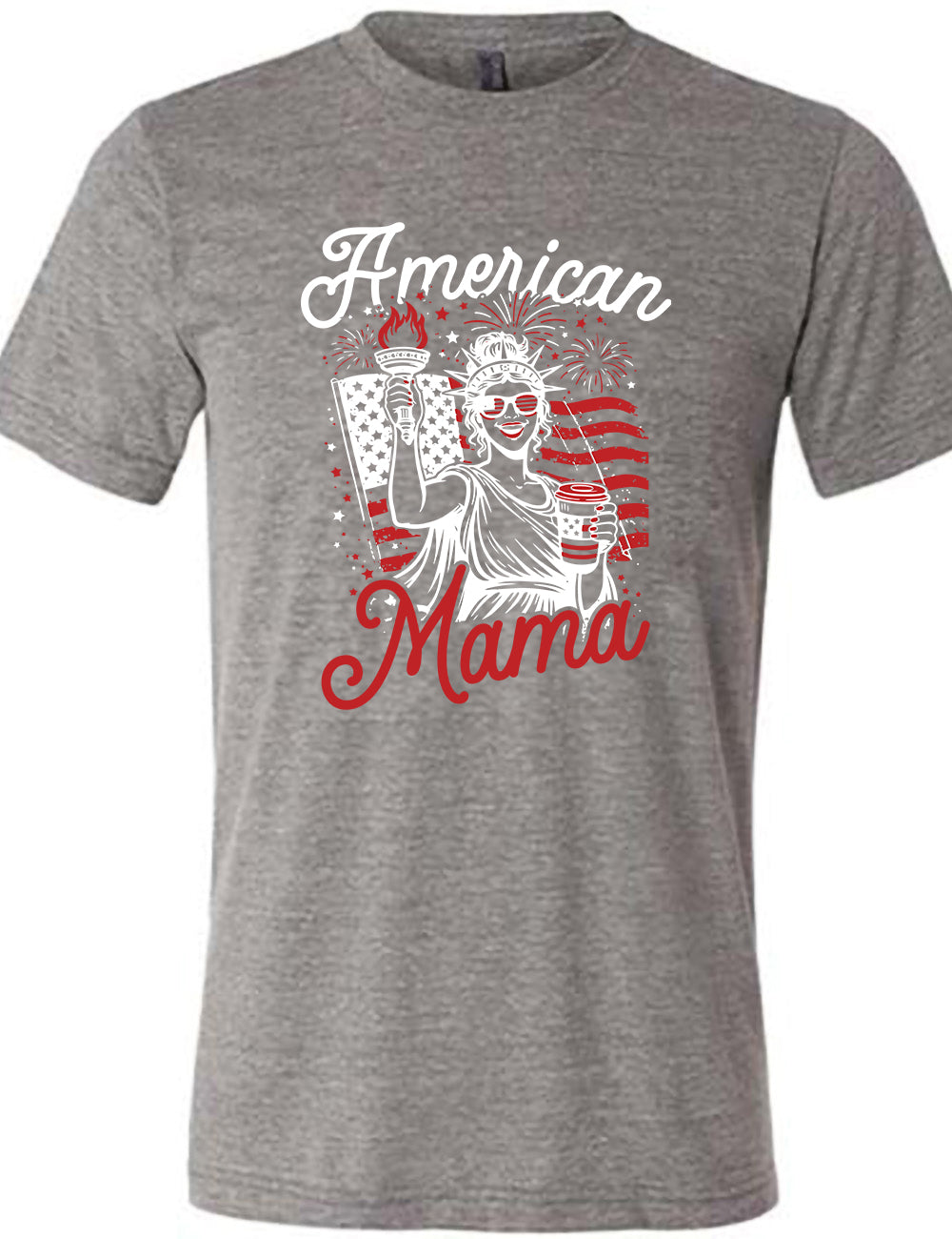 grey unisex tee with the graphic of the statue of liberty in front of an American flag, fireworks above, wearing American flag sunglasses, holding a American flag coffee cup, with the words "American Mama" surrounding it