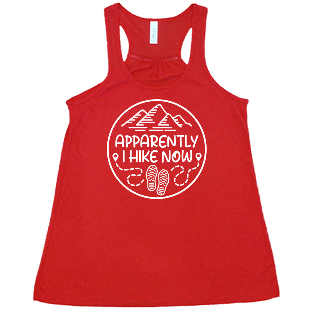Red colored flowy tank with a mountain and shoes graphic on it that says "Apparently I Hike Now" 