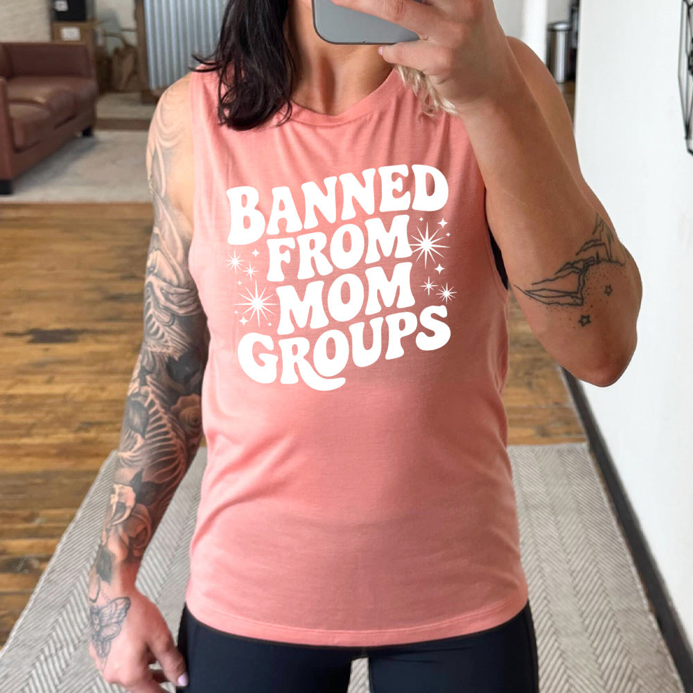 peach muscle tank with the words "banned from mom groups" on it, with stars on either side of the words "from mom"