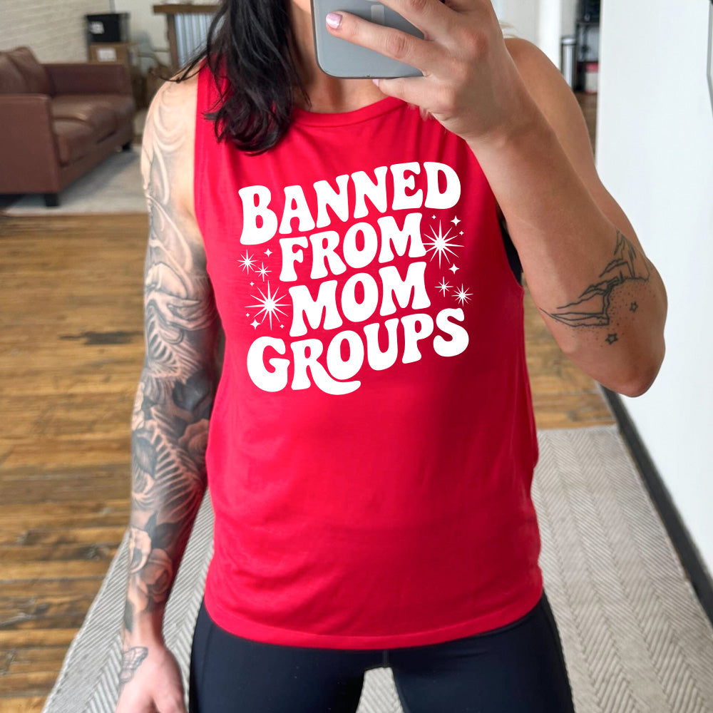 red muscle tank with the words "banned from mom groups" on it, with stars on either side of the words "from mom"
