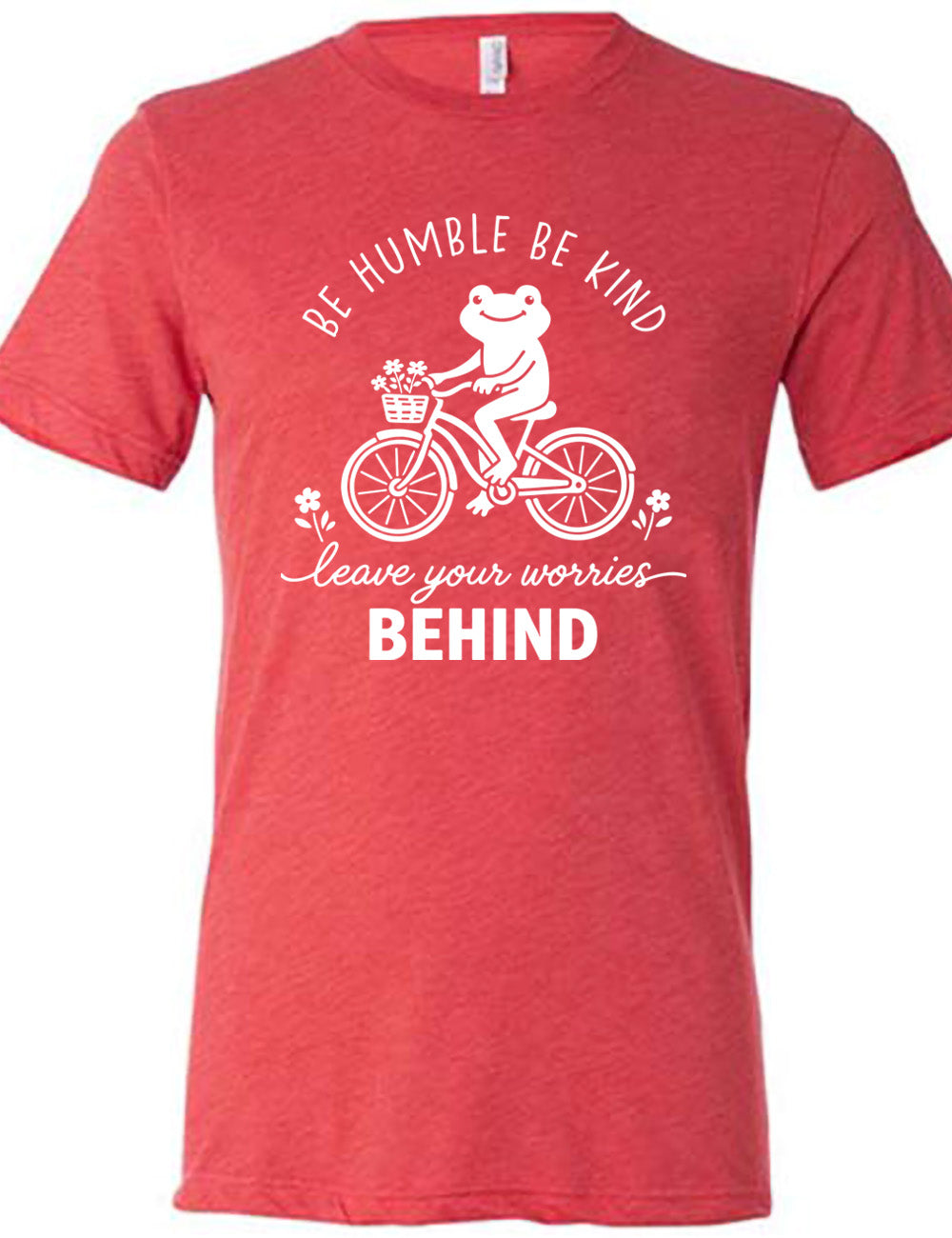 red unisex tee with the graphic of a happy frog riding a bike that has a basket of flowers attached, with a flower in front and behind the bike, and the wording arching above and ending below saying "be humble be kind leave your worries BEHIND"