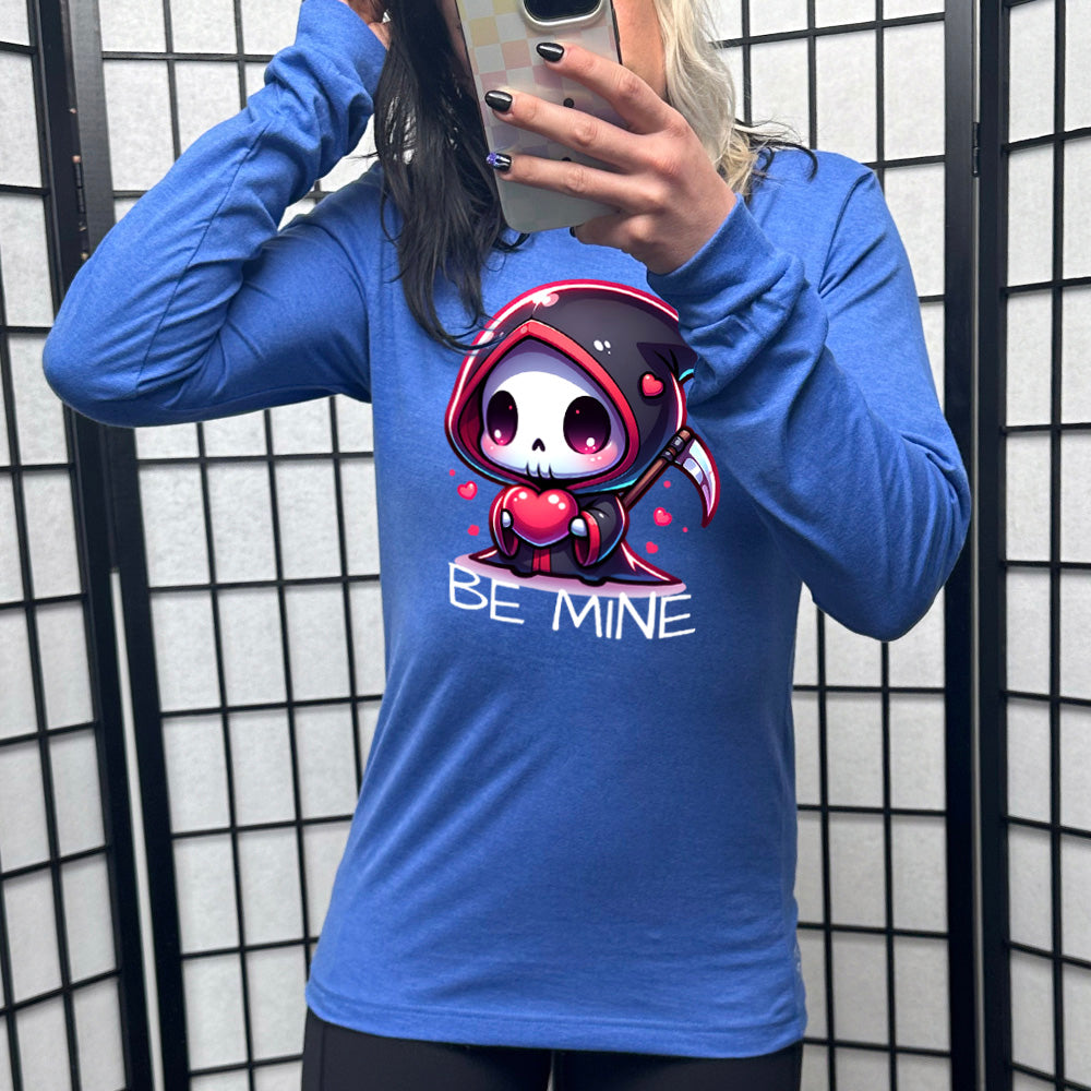 heather true royal long sleeve with large graphics of a cartoony grim reaper holding a heart, with little hearts surrounding, and the words "be mine" on it