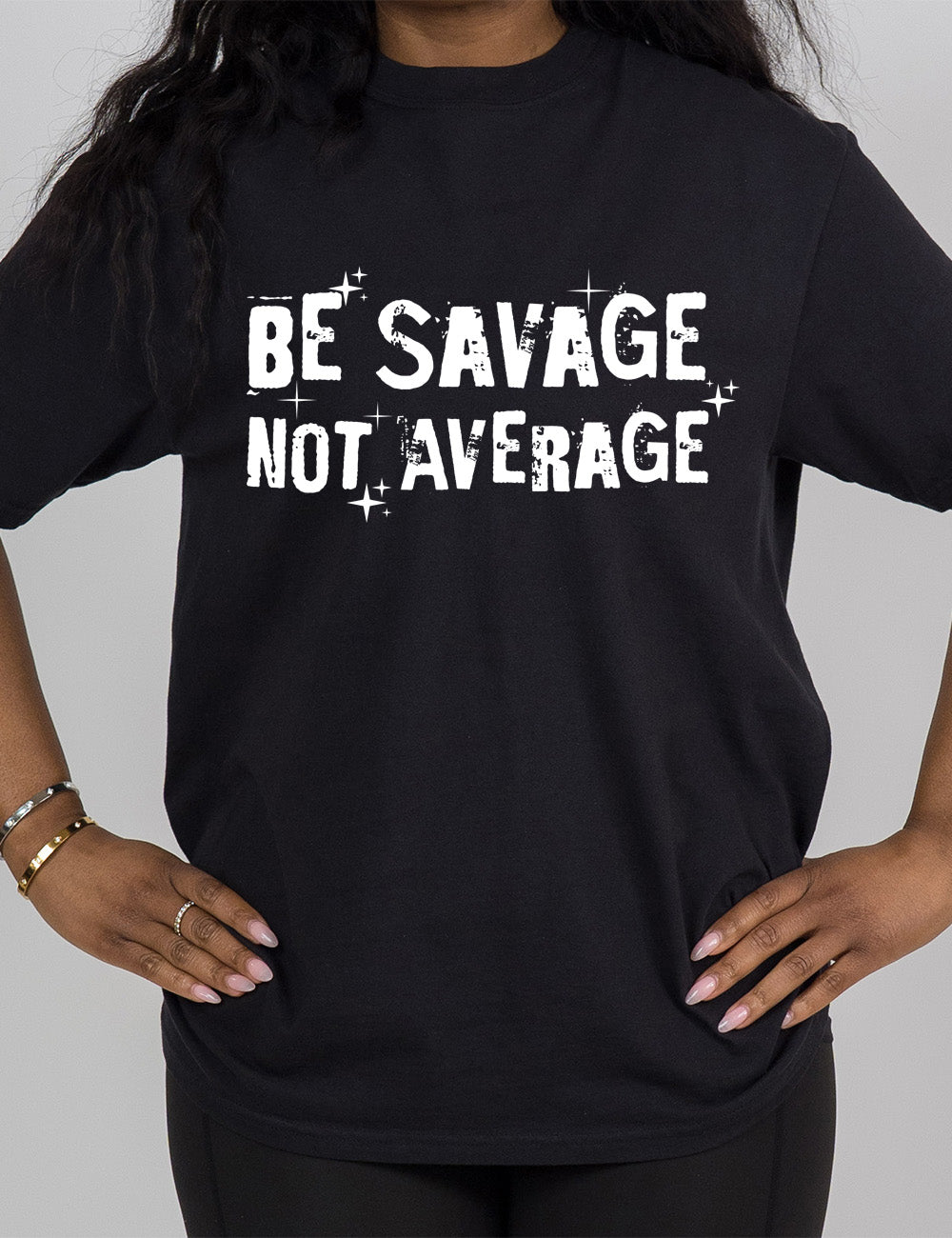 black modern tee with the words saying "be savage not average" on it, embellished with stars and shadowing on the words