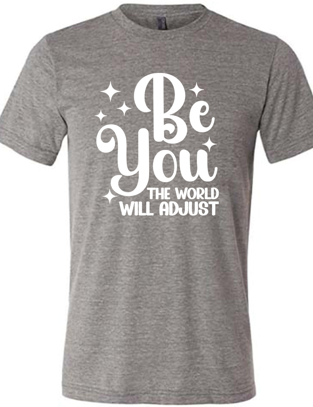 grey unisex tee with the words "be you" in big letters, surrounded by a few little stars, followed by the words "the world will adjust" underneath
