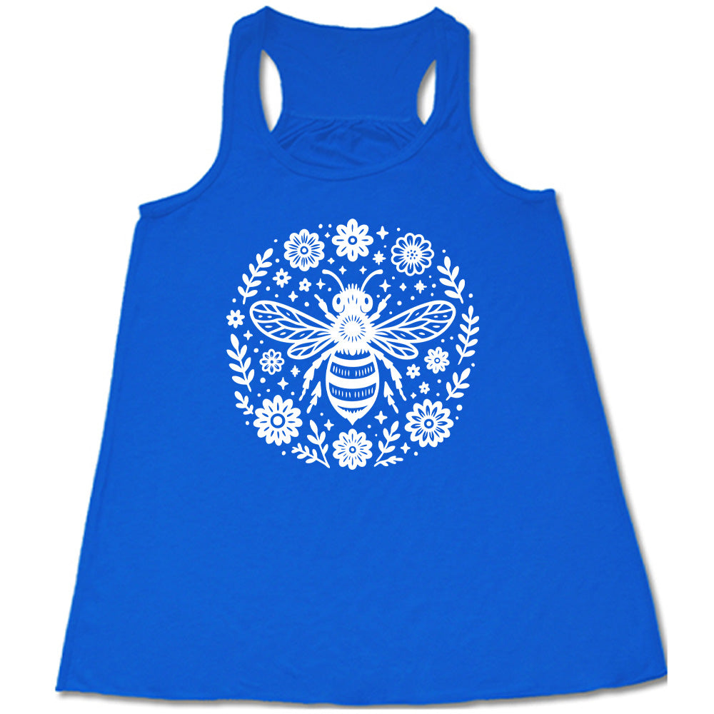 blue flowy racerback tank with the graphic of a boho circled design filled with flowers of varied size, some branches, some stars, and in the center a fancy bee