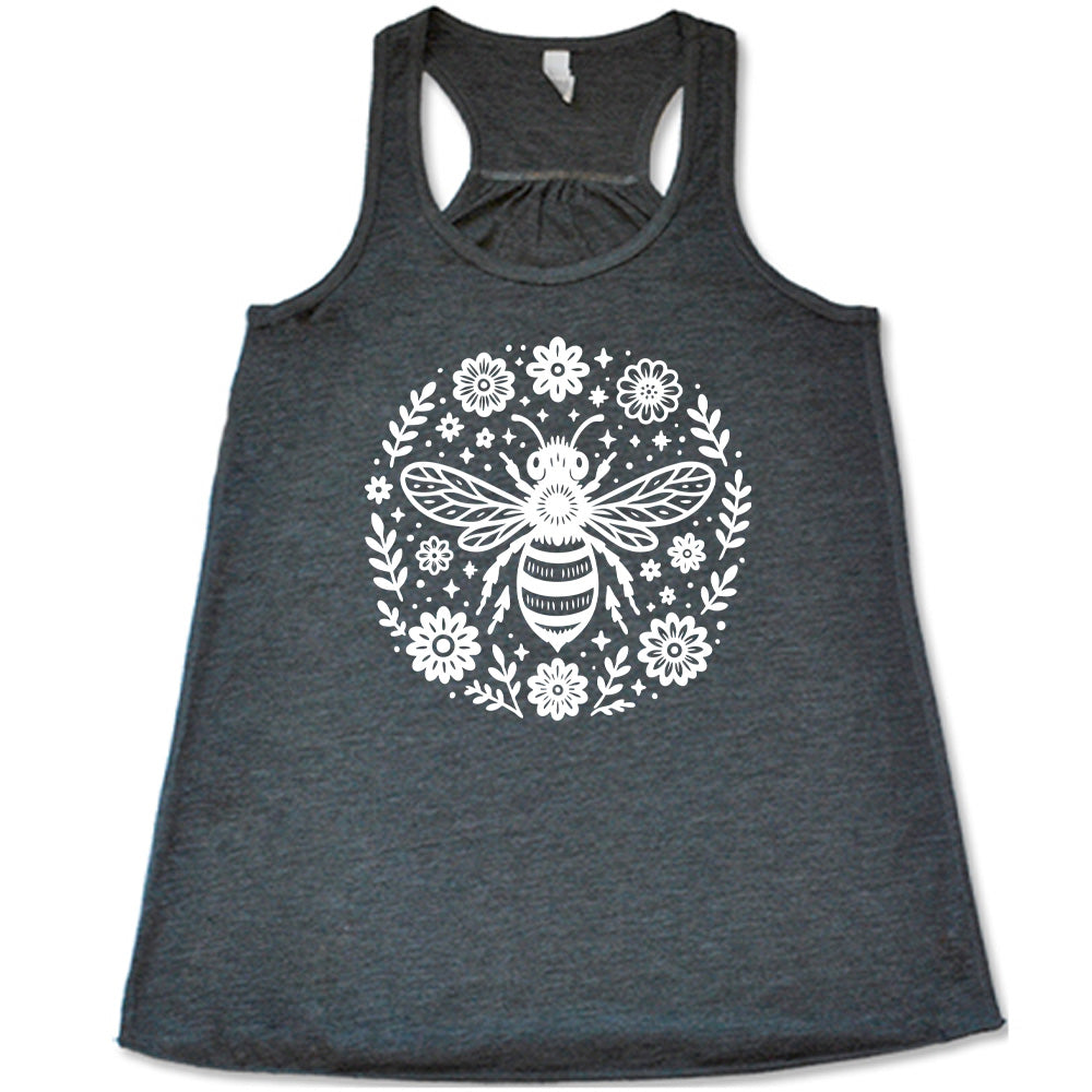 grey flowy racerback tank with the graphic of a boho circled design filled with flowers of varied size, some branches, some stars, and in the center a fancy bee