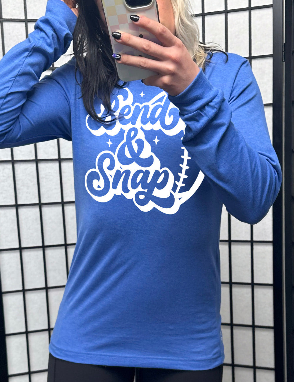 heather true royal long sleeve tee with the words in cursive saying "Bend & Snap" with the outline graphic of a football slightly underneath