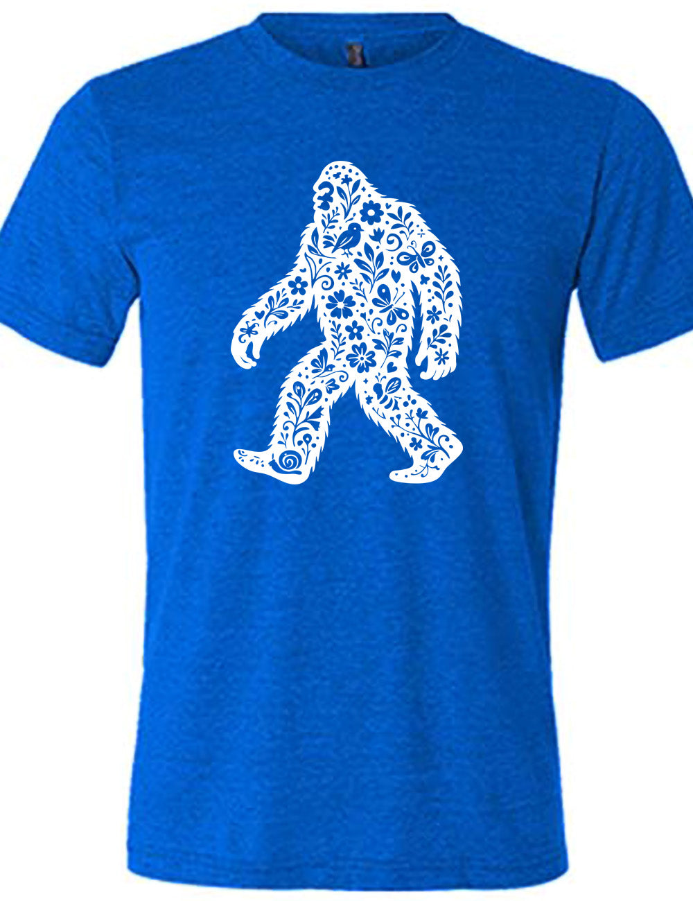blue unisex tee with the graphic white cutout of bigfoot, which is overlayed with black flowers, plants, birds, bees, snails, and butterflies