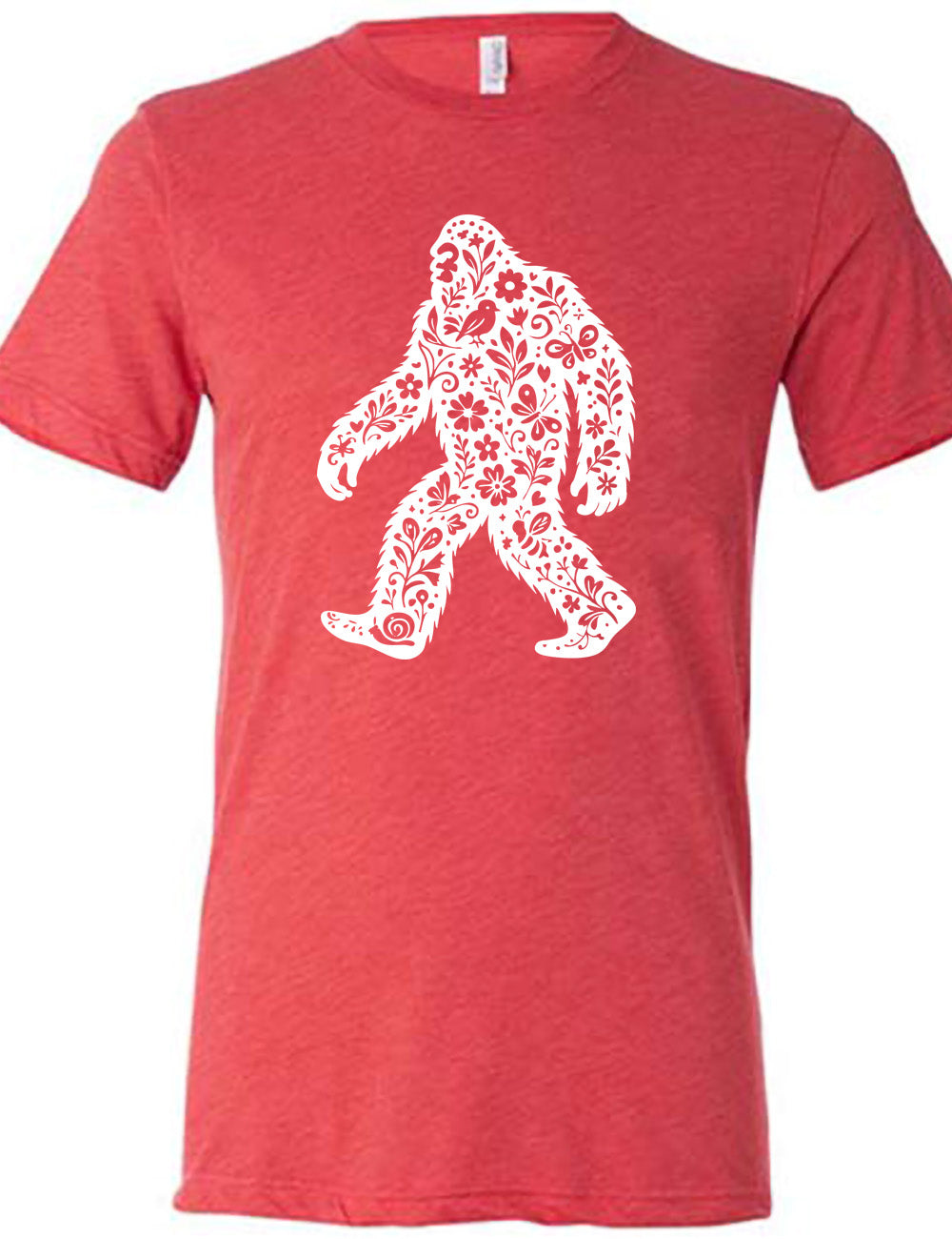 red unisex tee with the graphic white cutout of bigfoot, which is overlayed with black flowers, plants, birds, bees, snails, and butterflies