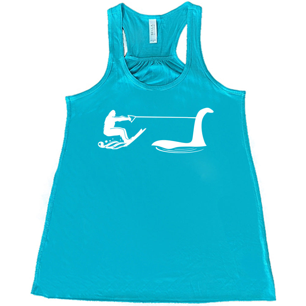 Teal colored flowy tank with bigfoot wakeboarding with Nessie graphic on it