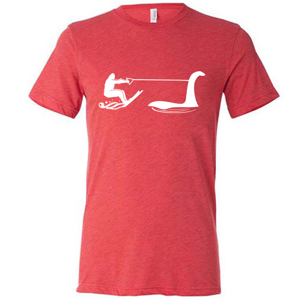 Red colored shirt with bigfoot wakeboarding with Nessie graphic on it