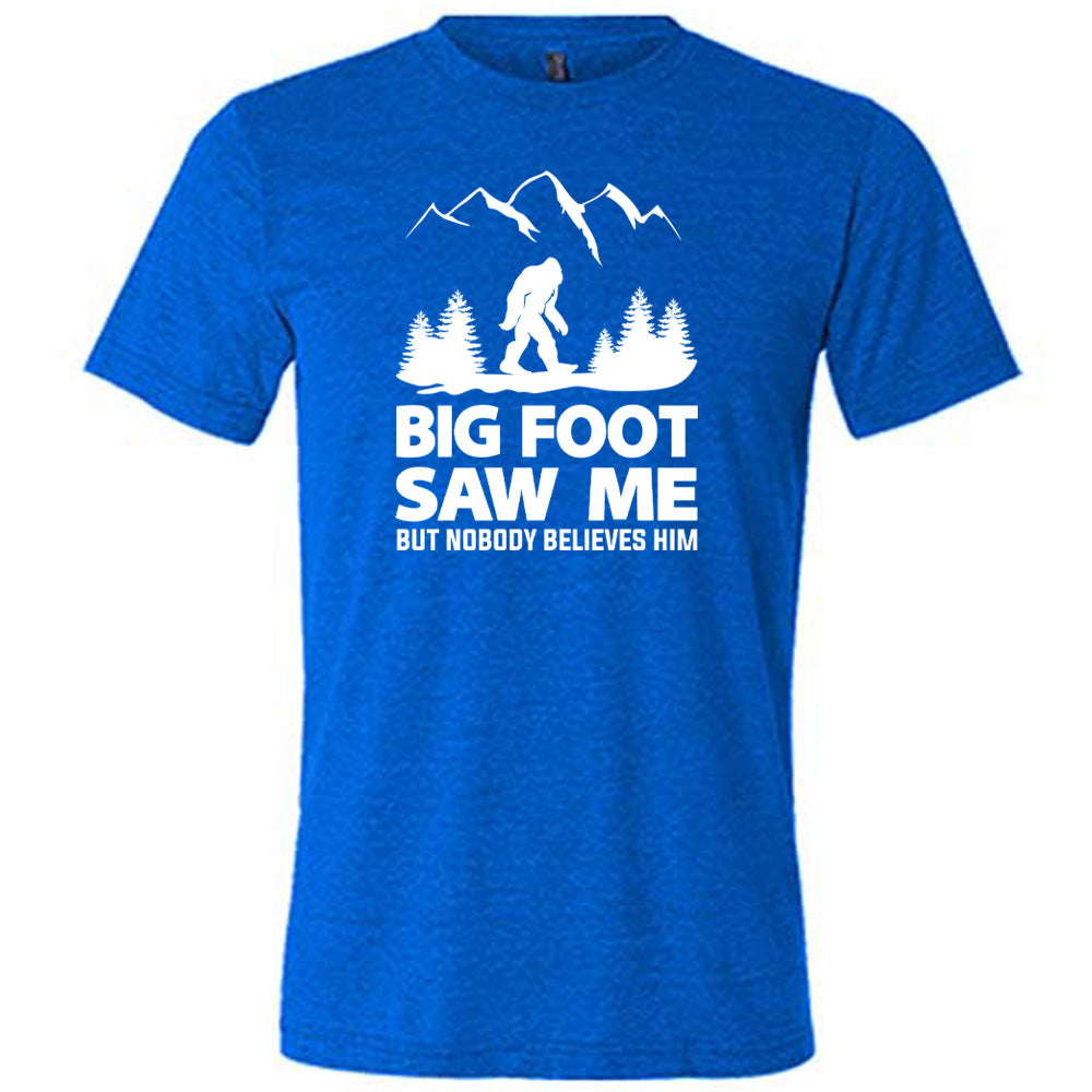 Blue colored shirt with bigfoot in the woods graphic on it that says "Bigfoot Saw Me But Nobody Believes Him"