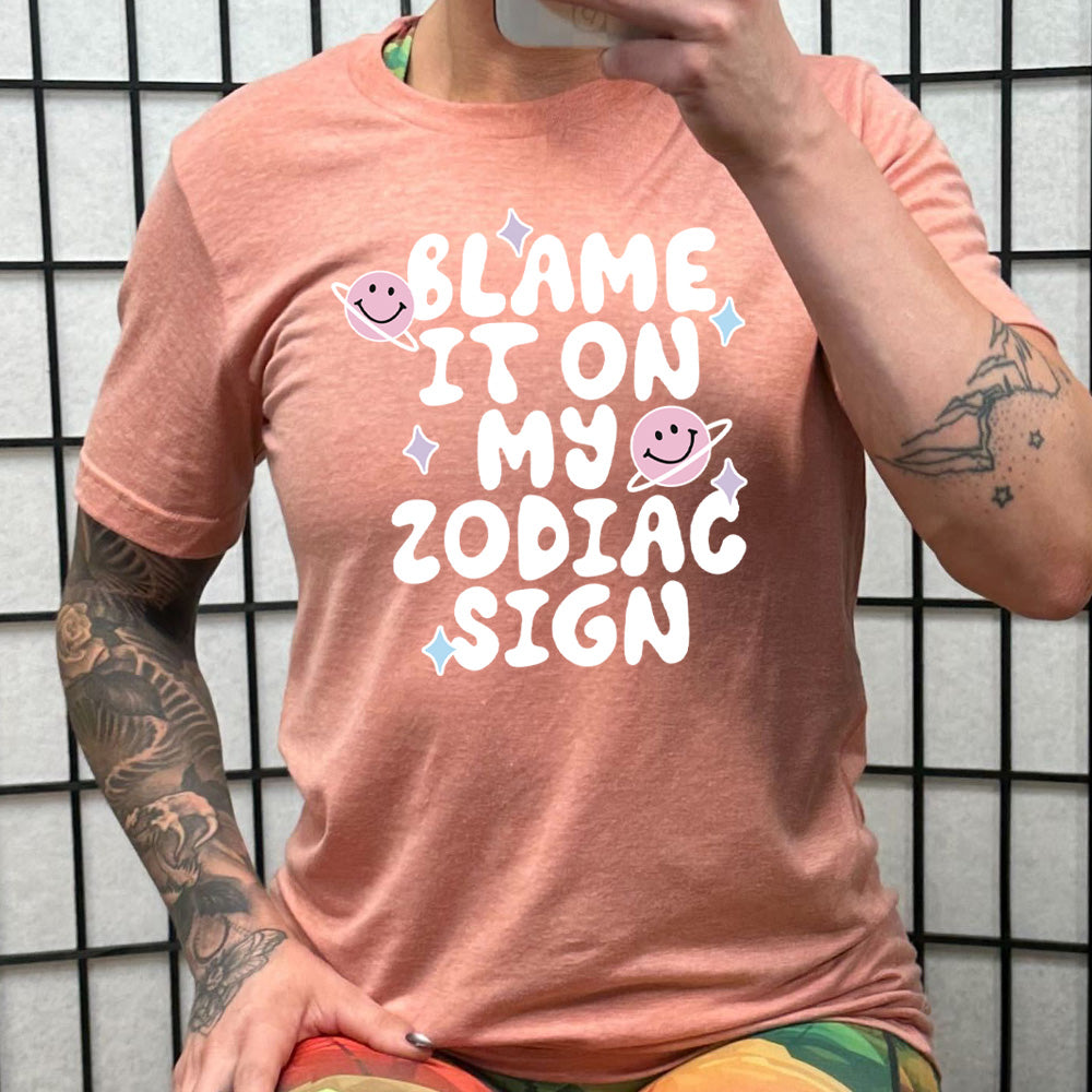 coral shirt with the text "Blame It On My Zodiac Sign" on it