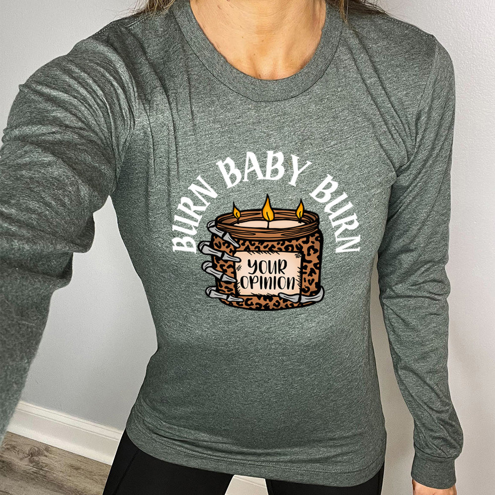 heather forest long sleeve tee with the text "Burn Baby Burn" on it, with the graphic of a skeletal hand hoping a leopard print candle, with three wicks alight, that has the words "your opinion" on it