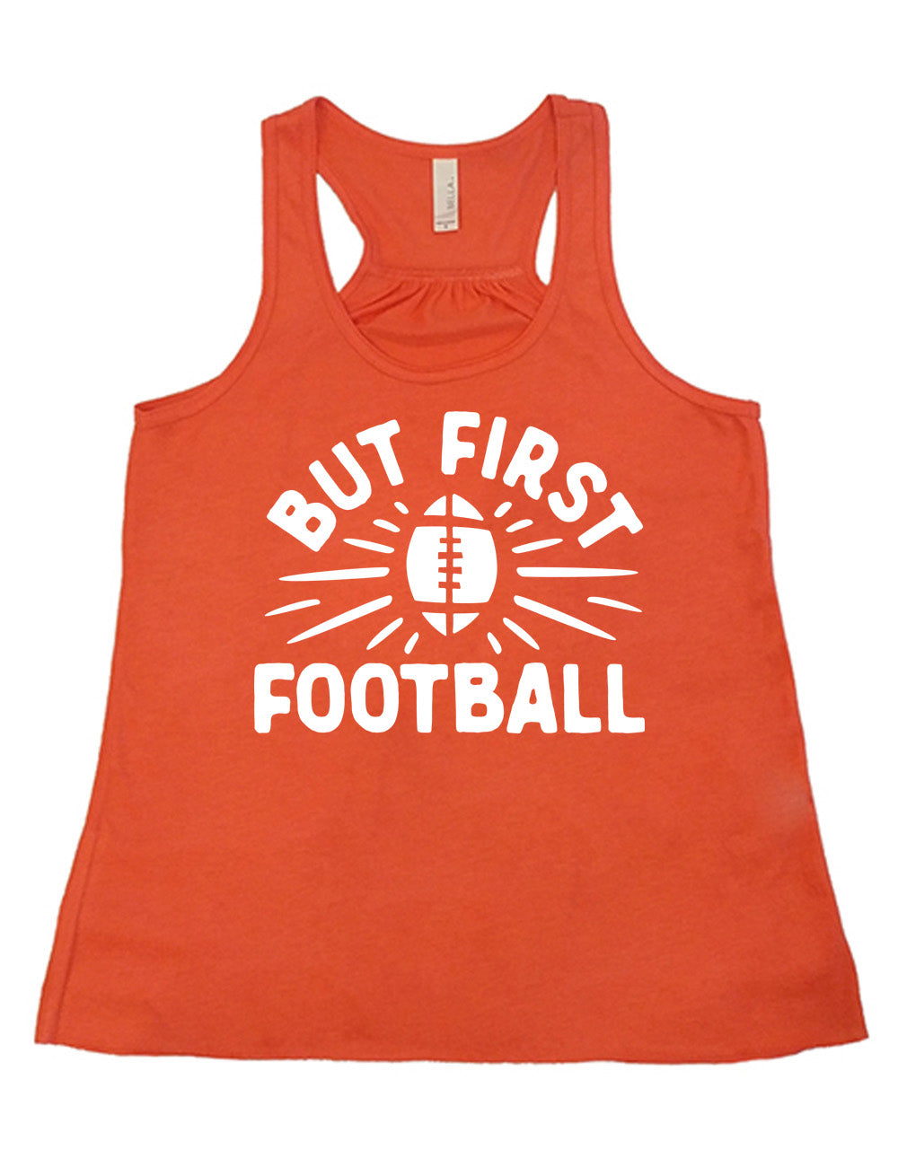 coral flowy racerback tank with the words "but first football" in capital font, with "But first" arching over the graphic of a football, with rays beaming off of it