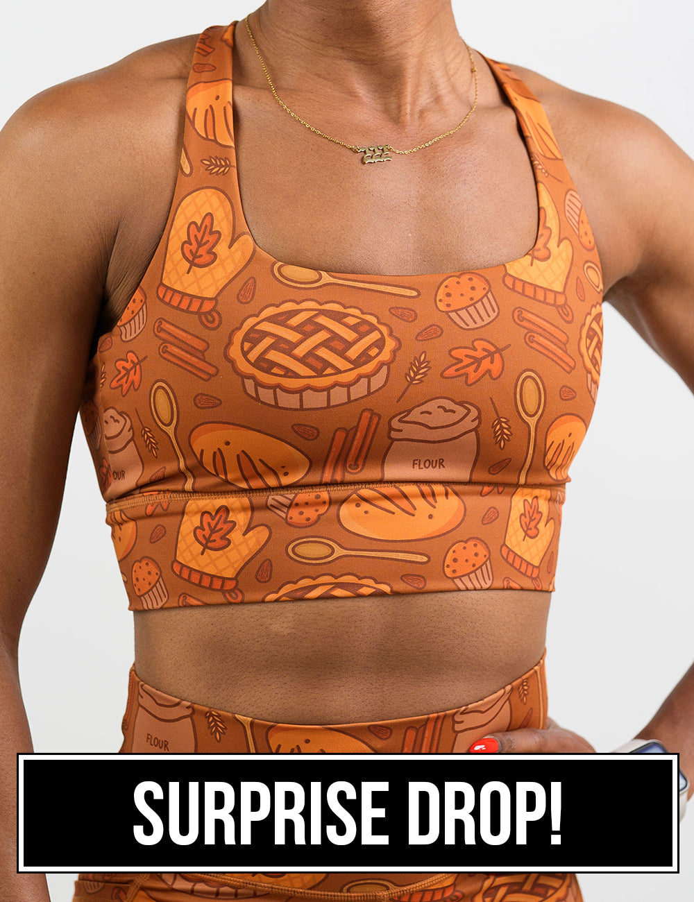 front of the orange baking themed sports bra surprise drop