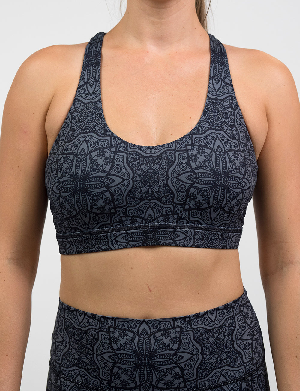 front of black mandala pattern butterfly back bra against a white background