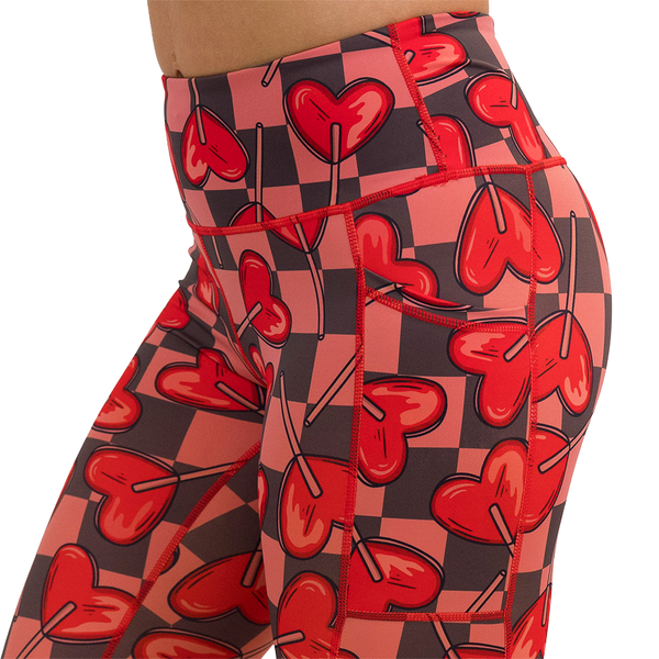 close up of heart lollypops on a checker board background pattern leggings 