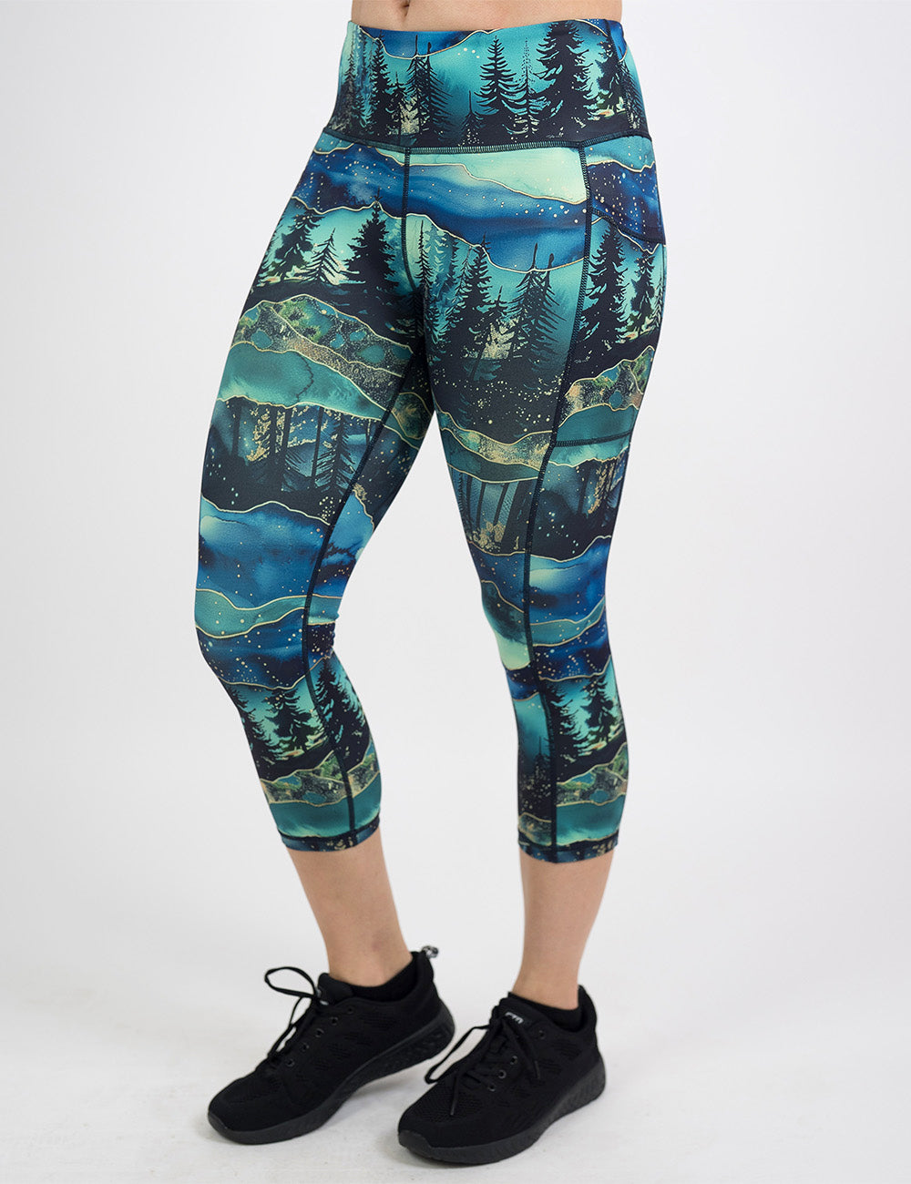 front of the capri aurora forest pattern leggings against a white background